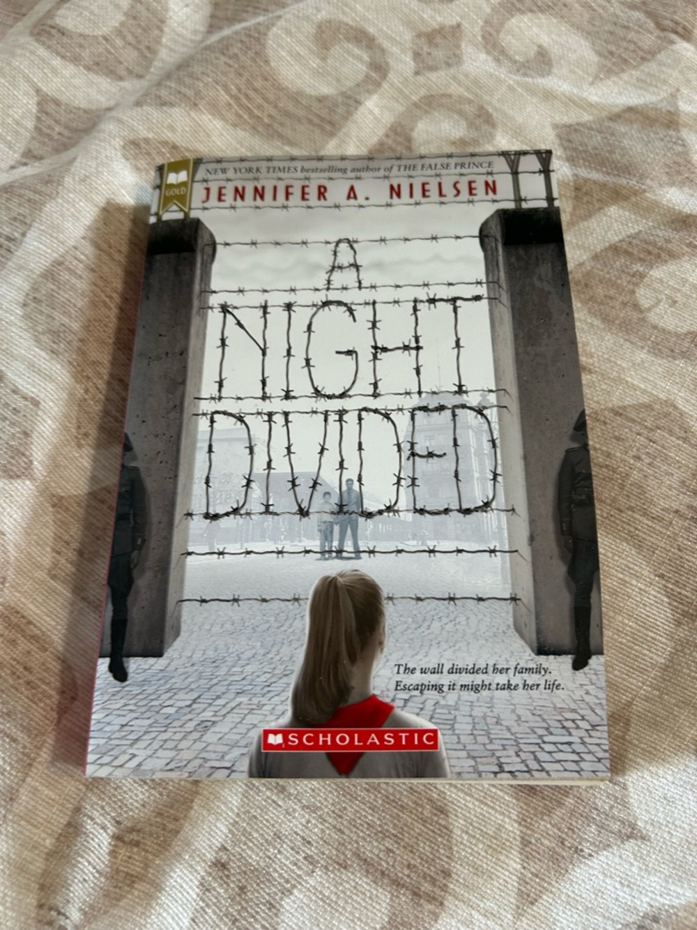 Scholastic A Night Divided Gold Beige Brown Back Cover with Red Accent